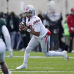 
              Ohio State quarterback C.J. Stroud looks downfield during the first half of an NCAA college football game against Michigan State, Saturday, Oct. 8, 2022, in East Lansing, Mich. (AP Photo/Carlos Osorio)
            