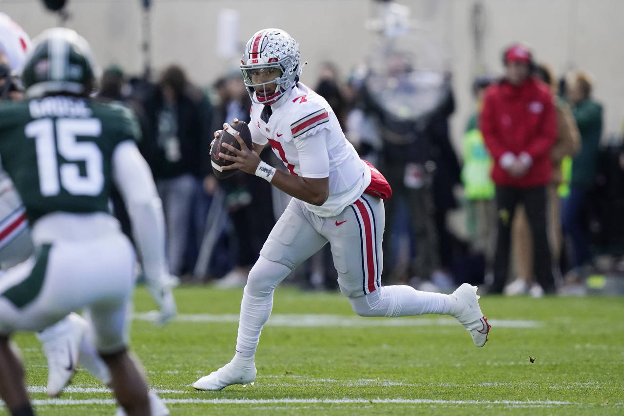 Ohio State quarterback C.J. Stroud looks downfield during the first half of an NCAA college footbal...
