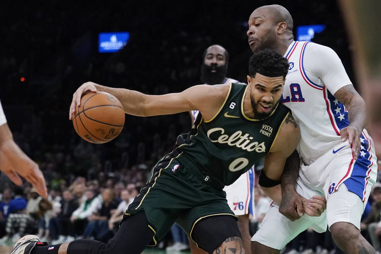 Boston Celtics forward Jayson Tatum (0) drives to the basket against Philadelphia 76ers forward P.J...
