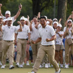 
              Tom Kim, of South Korea, celebrates after winning the 18th hole during their fourball match at the Presidents Cup golf tournament at the Quail Hollow Club, Saturday, Sept. 24, 2022, in Charlotte, N.C. (AP Photo/Chris Carlson)
            