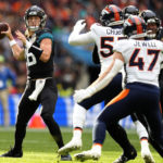 
              Jacksonville Jaguars quarterback Trevor Lawrence (16), left, concentrates during the NFL football game between Denver Broncos and Jacksonville Jaguars at Wembley Stadium London, Sunday, Oct. 30, 2022. (AP Photo/Kirsty Wigglesworth)
            