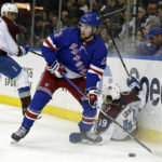 
              New York Rangers left wing Alexis Lafrenière (13) looks to pass as Colorado Avalanche defenseman Samuel Girard falls to the ice in the second period of an NHL hockey game Tuesday, Oct. 25, 2022, in New York. (AP Photo/Adam Hunger)
            
