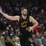 
              Cleveland Cavaliers' Kevin Love (0) celebrates after making a 3-point basket during the second half of an NBA basketball game against the Chicago Bulls, Saturday, Oct. 22, 2022, in Chicago. (AP Photo/Paul Beaty)
            