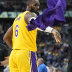
              Los Angeles Lakers forward LeBron James tosses his warm up jacket as he takes the court in the second half of an NBA basketball game against the Denver Nuggets Wednesday, Oct. 26, 2022, in Denver. (AP Photo/David Zalubowski)
            