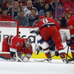 
              Carolina Hurricanes goaltender Frederik Andersen (31) freezes the puck as Brent Burns (8) and Paul Stastny (26) take care of Columbus Blue Jackets' Boone Jenner (38) during the second period of an NHL hockey game in Raleigh, N.C., Wednesday, Oct. 12, 2022. (AP Photo/Karl B DeBlaker)
            