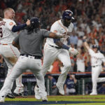 
              Houston Astros designated hitter Yordan Alvarez (44) celebrates with teammates after his three-run, walkout home run against the Seattle Mariners during the ninth inning in Game 1 of an American League Division Series baseball game in Houston,Tuesday, Oct. 11, 2022. (AP Photo/David J. Phillip)
            