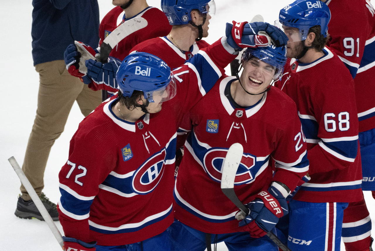 Montreal Canadiens' Juraj Slafkovsky, front right, and teammate Arber Xhekaj celebrate their victor...