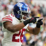 
              New York Giants running back Saquon Barkley (26) celebrates a touchdown during the second half of an NFL football game against the Green Bay Packers at the Tottenham Hotspur stadium in London, Sunday, Oct. 9, 2022. (AP Photo/Alastair Grant)
            