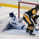 
              Pittsburgh Penguins' Sidney Crosby (87) scores past Tampa Bay Lightning goaltender Brian Elliott during the first period of an NHL hockey game in Pittsburgh, Saturday, Oct. 15, 2022. (AP Photo/Gene J. Puskar)
            