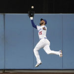 
              Los Angeles Dodgers center fielder Cody Bellinger makes a leaping catch on a line drive by San Diego Padres' Austin Nola during the sixth inning in Game 2 of a baseball NL Division Series, Wednesday, Oct. 12, 2022, in Los Angeles. (AP Photo/Mark J. Terrill)
            