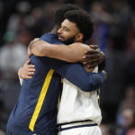 
              Denver Nuggets forward Jeff Green, left, hugs guard Jamal Murray as he takes the court for the first time since being injured in 2020 as the Nuggets host the Oklahoma City Thunder in the first half of an NBA preseason basketball game Monday, Oct. 3, 2022, in Denver. (AP Photo/David Zalubowski)
            