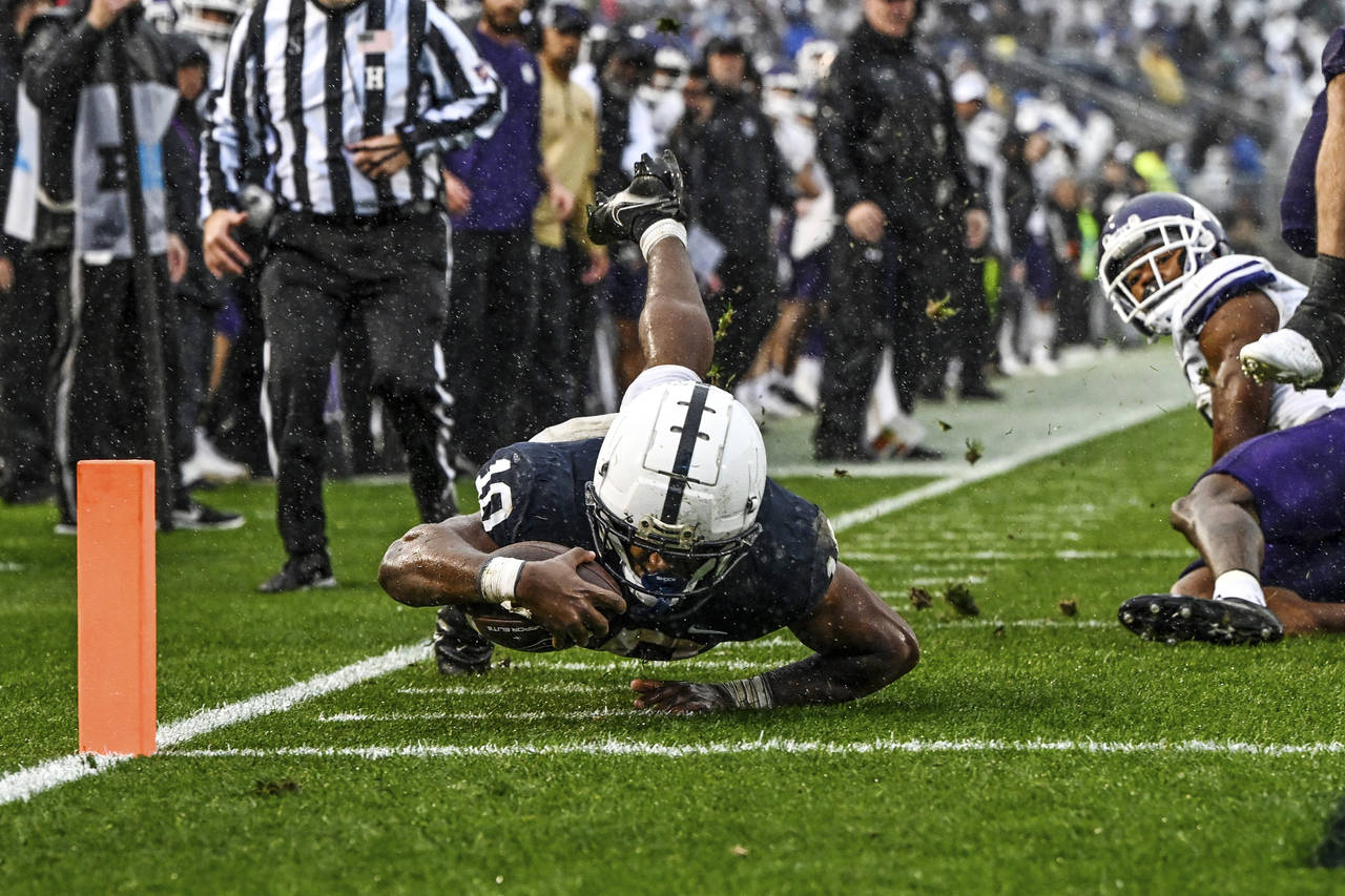 Penn State running back Nicholas Singleton (10) dives short of the goal line during the first half ...