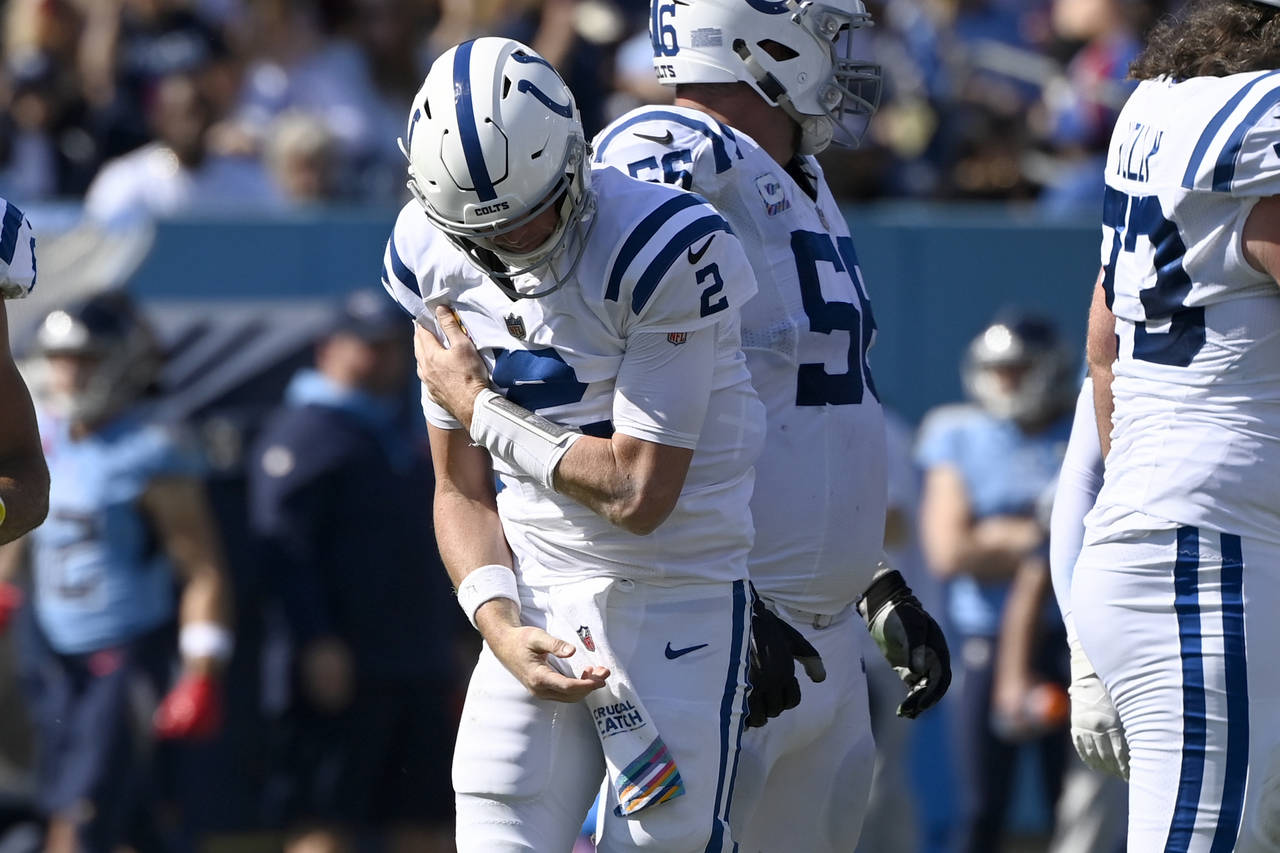Indianapolis Colts quarterback Matt Ryan holds his shoulder after being sacked during the first hal...