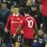 
              Manchester United's Cristiano Ronaldo, left, celebrates with teammate Marcus Rashford after scoring his side's second goal during the Premier League soccer match between Everton and Manchester United at Goodison Park, in Liverpool, England, Sunday Oct. 9, 2022. (AP Photo/Jon Super)
            