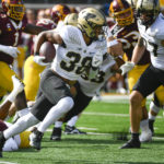 
              Purdue running back Dylan Downing (38) runs for a gain against Minnesota during the first half an NCAA college football game on Saturday, Oct. 1, 2022, in Minneapolis. Purdue won 20-10. (AP Photo/Craig Lassig)
            