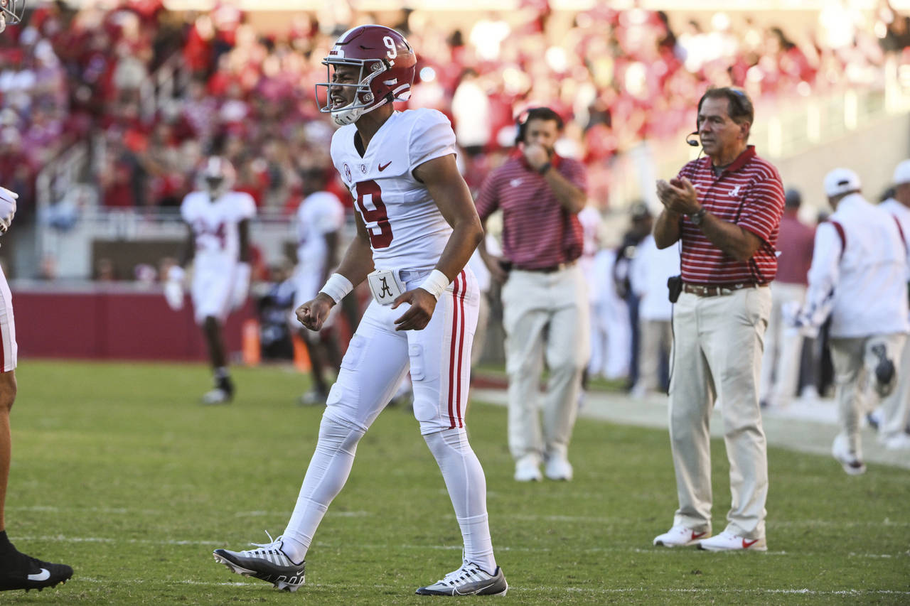 Alabama quarterback Bryce Young and coach Nick Saban celebrate a touchdown against Arkansas during ...