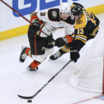 
              Anaheim Ducks defenseman John Klingberg (3) and Boston Bruins center Charlie Coyle (13) vie for control of the puck during the second period of an NHL hockey game Thursday, Oct. 20, 2022, in Boston. (AP Photo//Steven Senne)
            