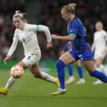 
              England's Lauren Hemp, left, challenges for the ball with United States' Hailie Mace during the women's friendly soccer match between England and the US at Wembley stadium in London, Friday, Oct. 7, 2022. (AP Photo/Kirsty Wigglesworth)
            