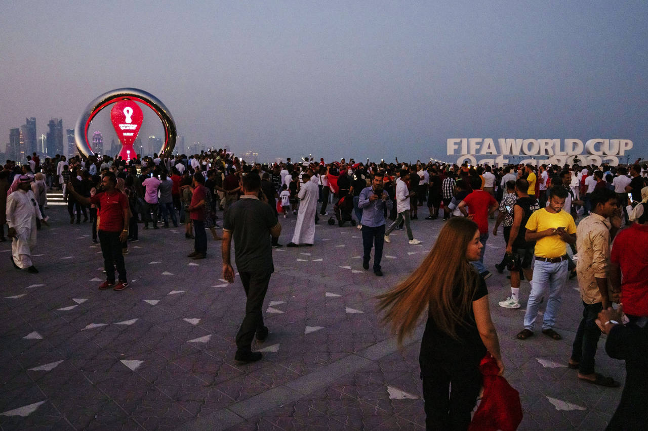 People take photographs in front of the official FIFA World Cup Countdown Clock on Doha's corniche,...