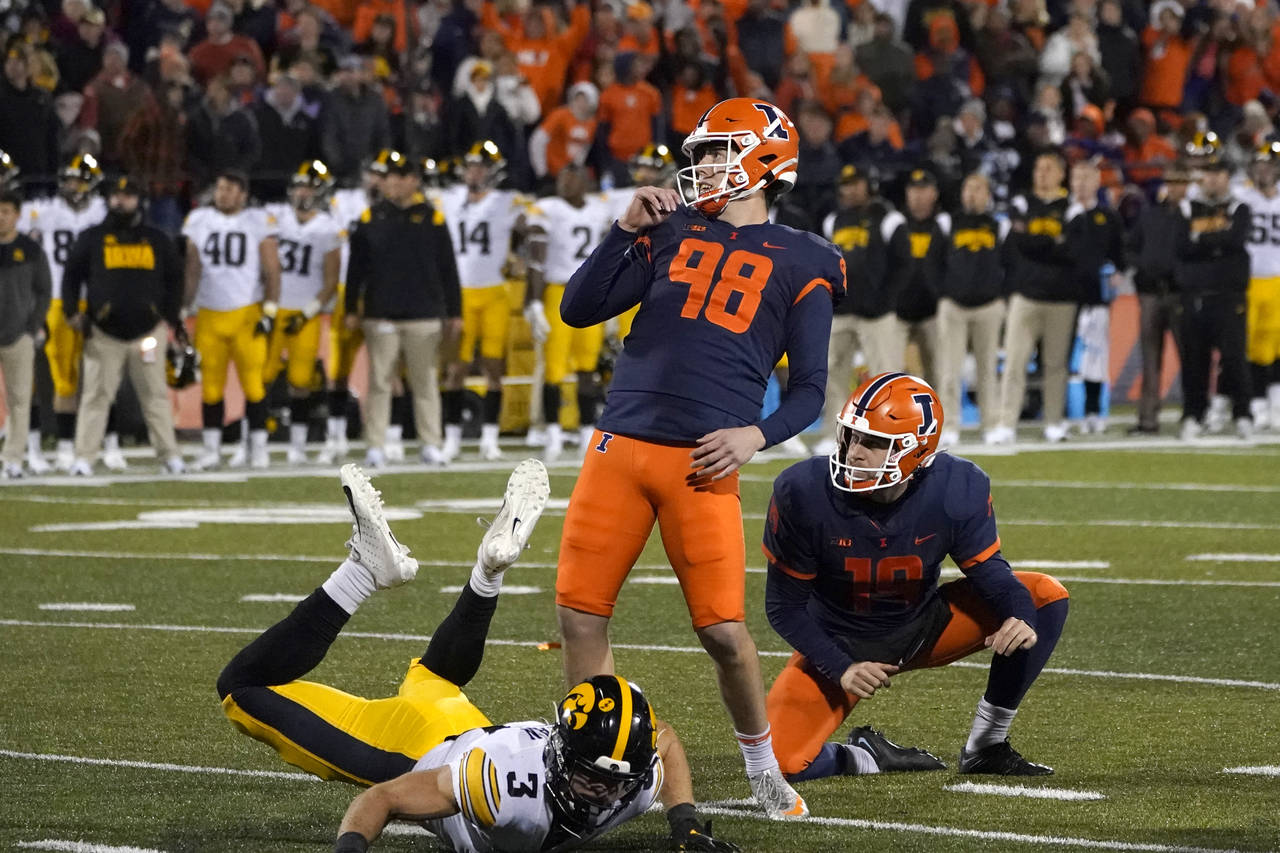 Illinois place kicker Fabrizio Pinton watches his go ahead field goal off the hold of Hugh Robertso...