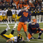 
              Illinois place kicker Fabrizio Pinton watches his go ahead field goal off the hold of Hugh Robertson during the second half of an NCAA college football game Saturday, Oct. 8, 2022, in Champaign, Ill. Illinois won 9-6. (AP Photo/Charles Rex Arbogast)
            