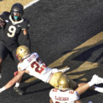 
              Wake Forest wide receiver A.T. Perry (9) catches a touchdown pass as Boston College defensive back Cole Batson (23) defends during the first half of an NCAA college football game in Winston-Salem, N.C., Saturday, Oct. 22, 2022. (AP Photo/Chuck Burton)
            