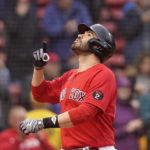 
              Boston Red Sox's J.D. Martinez celebrates his three-run home run as he arrives home in the first inning of a baseball game against the Tampa Bay Rays, Wednesday, Oct. 5, 2022, in Boston. (AP Photo/Steven Senne)
            