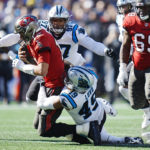 
              Tampa Bay Buccaneers quarterback Tom Brady (12) is sacked by Carolina Panthers linebacker Frankie Luvu (49) and teammate defensive end Yetur Gross-Matos (97) during the second half of an NFL football game Sunday, Oct. 23, 2022, in Charlotte, N.C. (AP Photo/Rusty Jones)
            
