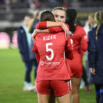 
              Kansas City Current defender Kate Del Fava, back, and forward Cece Kizer (5) embrace after the NWSL championship soccer match against the Portland Thorns FC, Saturday, Oct. 29, 2022, in Washington. Portland won 2-0. (AP Photo/Nick Wass)
            