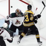 
              Boston Bruins' Charlie Coyle (13) scores against Arizona Coyotes' Karel Vejmelka (70) during the first period of an NHL hockey game, Saturday, Oct. 15, 2022, in Boston. (AP Photo/Michael Dwyer)
            
