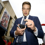 
              Washington Capitals goaltender Darcy Kuemper signs for fans on the red carpet before an NHL hockey game against the Boston Bruins, Wednesday, Oct. 12, 2022, in Washington. (AP Photo/Nick Wass)
            