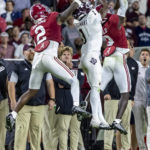 
              Texas A&M wide receiver Evan Stewart (1) grabs a pass between Alabama defensive backs DeMarcco Hellams (2) and Terrion Arnold (3) during the second half of an NCAA college football game Saturday, Oct. 8, 2022, in Tuscaloosa, Ala. (AP Photo/Vasha Hunt)
            