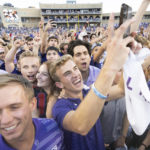 
              TCU fans celebrate on the field after their team defeated Oklahoma State in double overtime of an NCAA college football game in Fort Worth, Texas, Saturday, Oct. 15, 2022. TCU won 43-40. (AP Photo/Sam Hodde)
            