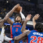 
              Detroit Pistons guard Cade Cunningham (2) shoots while being defended by Indiana Pacers guard Bennedict Mathurin during the first half of an NBA basketball game in Indianapolis, Saturday, Oct. 22, 2022. (AP Photo/Doug McSchooler)
            