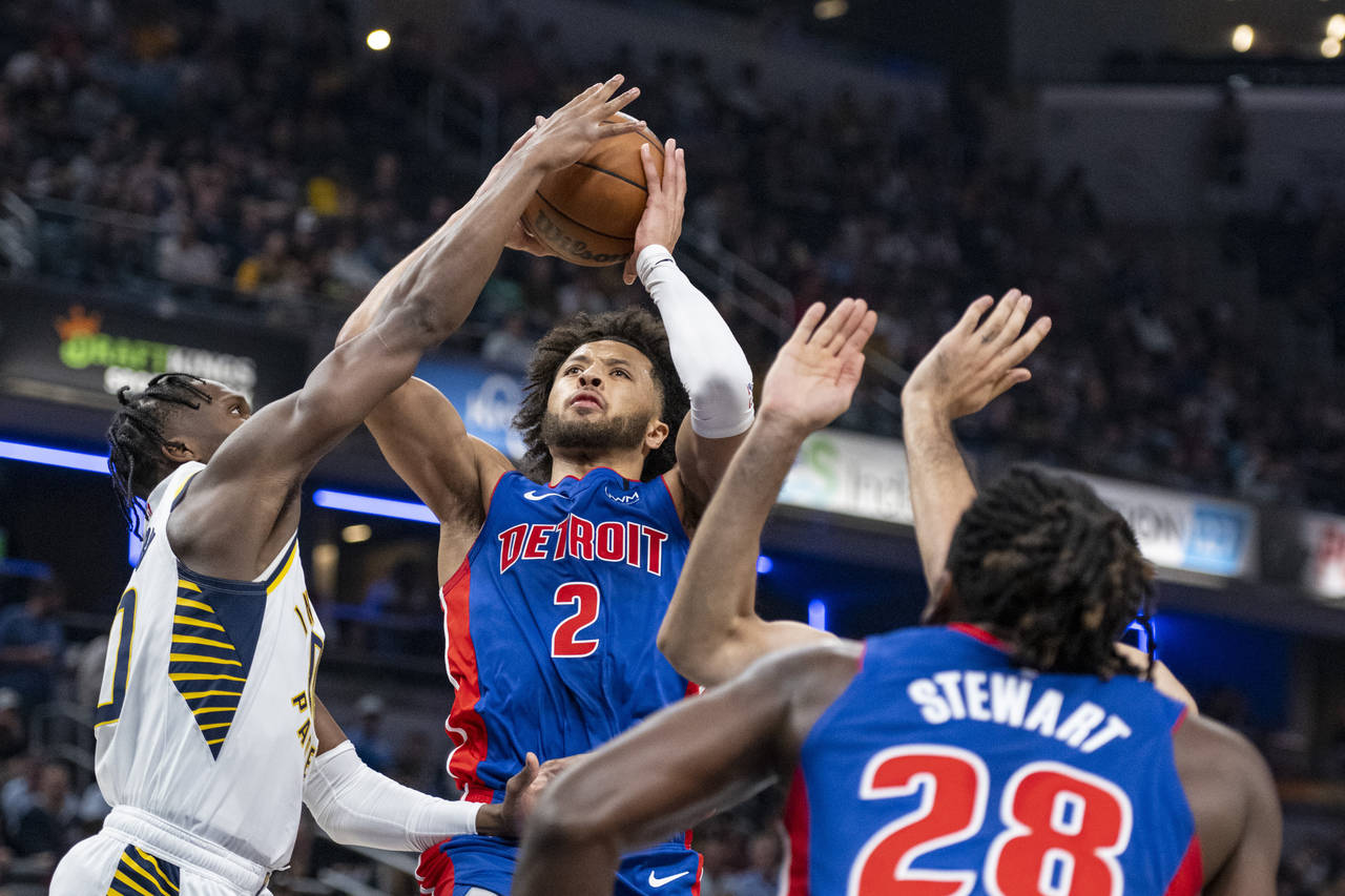 Detroit Pistons guard Cade Cunningham (2) shoots while being defended by Indiana Pacers guard Benne...