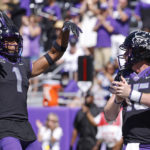 
              TCU quarterback Max Duggan (15) and teammate Quentin Johnston (1) celebrate Duggan's touchdown against Oklahoma during the second half of an NCAA college football game Saturday, Oct. 1, 2022, in Fort Worth, Texas. TCU won 55-24. (AP Photo/Ron Jenkins)
            