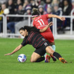 
              Kansas City Current midfielder Desiree Scott, back, battles for the ball against Portland Thorns FC midfielder Rocky Rodríguez, front, during the first half of the NWSL championship soccer match, Saturday, Oct. 29, 2022, in Washington. (AP Photo/Nick Wass) (edited)
            