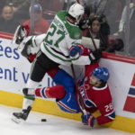
              Dallas Stars' Mason Marchment (27) hits Montreal Canadiens' Johnathan Kovacevic (26) during first-period NHL hockey game action Saturday, Oct. 22, 2022, in Montreal. (Ryan Remiorz/The Canadian Press via AP)
            