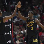 
              Cleveland Cavaliers' Caris LeVert (3) celebrates with teammate Evan Mobley (4) after dunking during the final minutes of the second half of an NBA basketball game against the Chicago Bulls, Saturday, Oct. 22, 2022, in Chicago. (AP Photo/Paul Beaty)
            