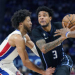 
              Orlando Magic forward Chuma Okeke (3) is defended by Detroit Pistons guard Cade Cunningham during the second half of an NBA basketball game, Wednesday, Oct. 19, 2022, in Detroit. (AP Photo/Carlos Osorio)
            