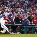 
              Philadelphia Phillies' Bryce Harper hits a two-run home run during the eighth inning in Game 5 of the baseball NL Championship Series between the San Diego Padres and the Philadelphia Phillies on Sunday, Oct. 23, 2022, in Philadelphia. (AP Photo/Matt Slocum)
            