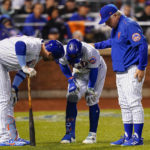 
              New York Mets manager Buck Showalter, right, and Pete Alonso check on Francisco Lindor (12) as he hunches over after fouling a ball off his knee during the fourth inning of Game 3 of a National League wild-card baseball playoff series against the San Diego Padres, Sunday, Oct. 9, 2022, in New York. (AP Photo/Frank Franklin II)
            