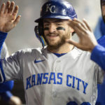 
              Kansas City Royals' Kyle Isbel is congratulated in the dugout after scoring on a double by MJ Melendez during the fourth inning of a baseball game against the Cleveland Guardians in Cleveland, Saturday, Oct. 1, 2022. Isbel drove in two runs earlier in the inning. (AP Photo/Phil Long)
            