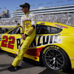
              Joey Logano leans on his car before the start of a NASCAR Cup Series auto race Sunday, Oct. 16, 2022, in Las Vegas. (AP Photo/John Locher)
            