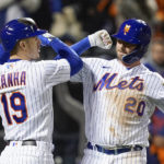 
              New York Mets Pete Alonso (20) is congratulated by Mark Canha (19) after Alonso hit a solo home run against the San Diego Padres during the fifth inning of Game 2 of a National League wild-card baseball playoff series, Saturday, Oct. 8, 2022, in New York. (AP Photo/John Minchillo)
            