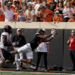 
              Oklahoma State wide receiver Bryson Green (9) catches the ball in front of Texas Tech's Malik Dunlap (24) during the first half of an NCAA college football game in Stillwater, Okla., Saturday, Oct. 8, 2022. (AP Photo/Mitch Alcala)
            
