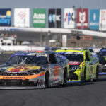 
              Noah Gragson (9) leads a pack of cars into Turn 5 during a NASCAR Xfinity auto race at Charlotte Motor Speedway on Saturday, Oct. 8, 2022, in Concord, N.C. (AP Photo/Matt Kelley)
            