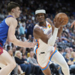 
              Oklahoma City Thunder guard Shai Gilgeous-Alexander, right, drives the lane as Denver Nuggets guard Christian Braun defends in the first half of an NBA basketball game Saturday, Oct. 22, 2022, in Denver. (AP Photo/David Zalubowski)
            