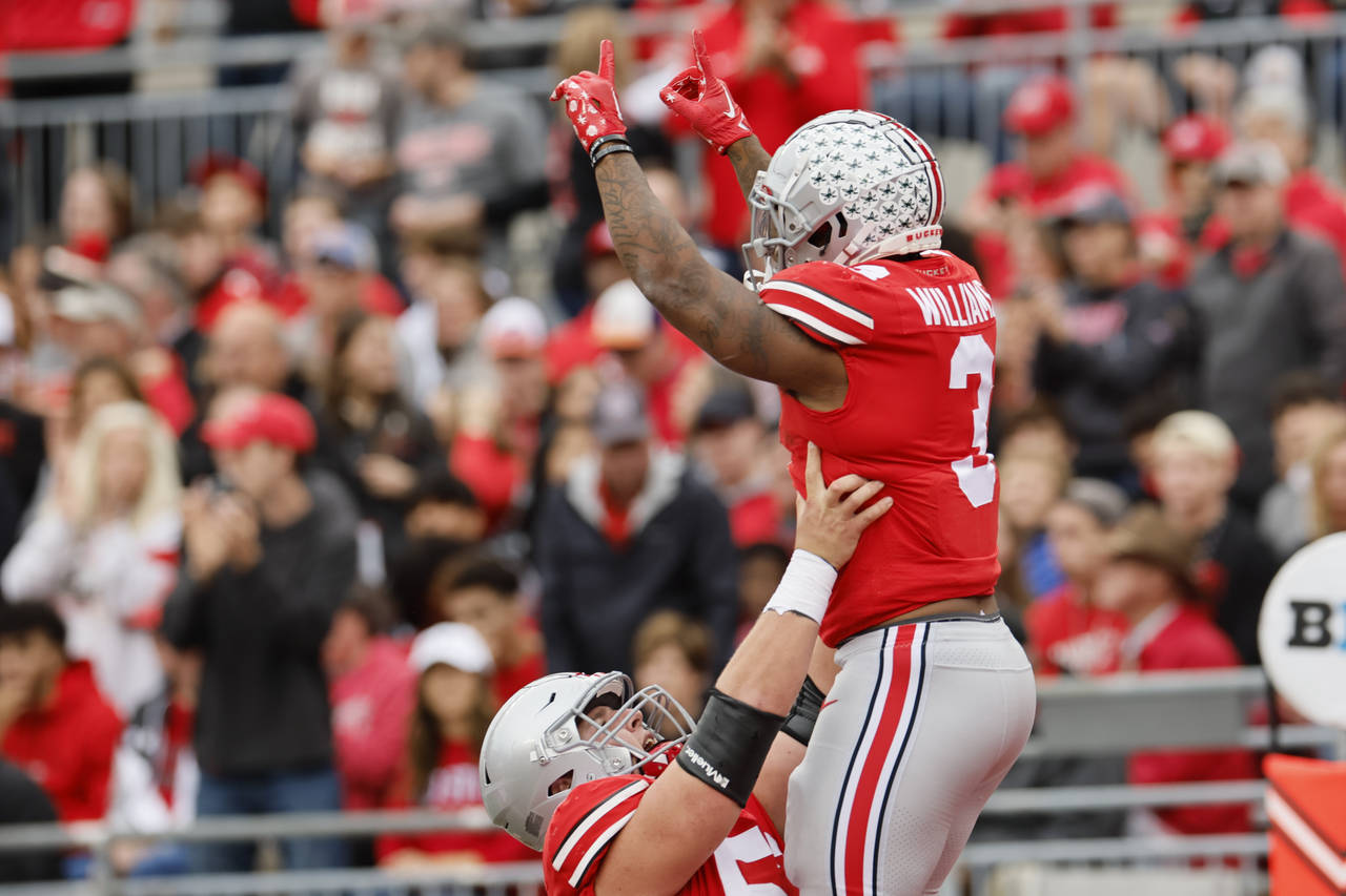 Ohio State running back Miyan Williams, top, celebrates his touchdown against Rutgers with teammate...