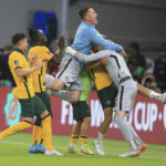 
              FILE - Australian players celebrate after winning in a penalty shoot-out during the World Cup 2022 qualifying play-off soccer match between Australia and Peru in Al Rayyan, Qatar, Monday, June 13, 2022. (AP Photo/Hussein Sayed, File)
            